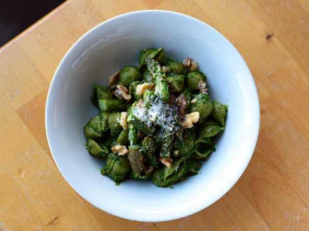 Pesto on shell pasta topped with asparagus and Parmesan cheese