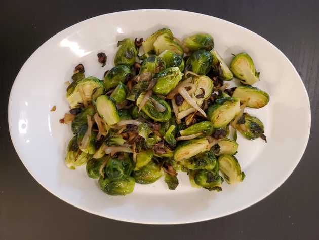 brussel sprouts with fried mushrooms and onions on plate